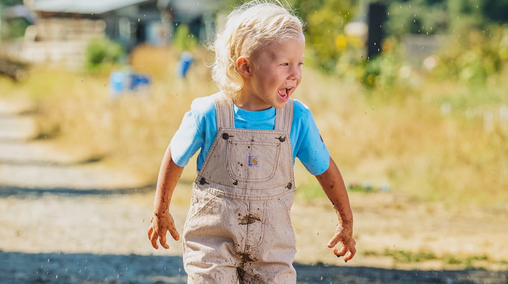 Infant's Infant Boy Carhartt Short Sleeve Onesie in blue & Brown Stripe overalls.