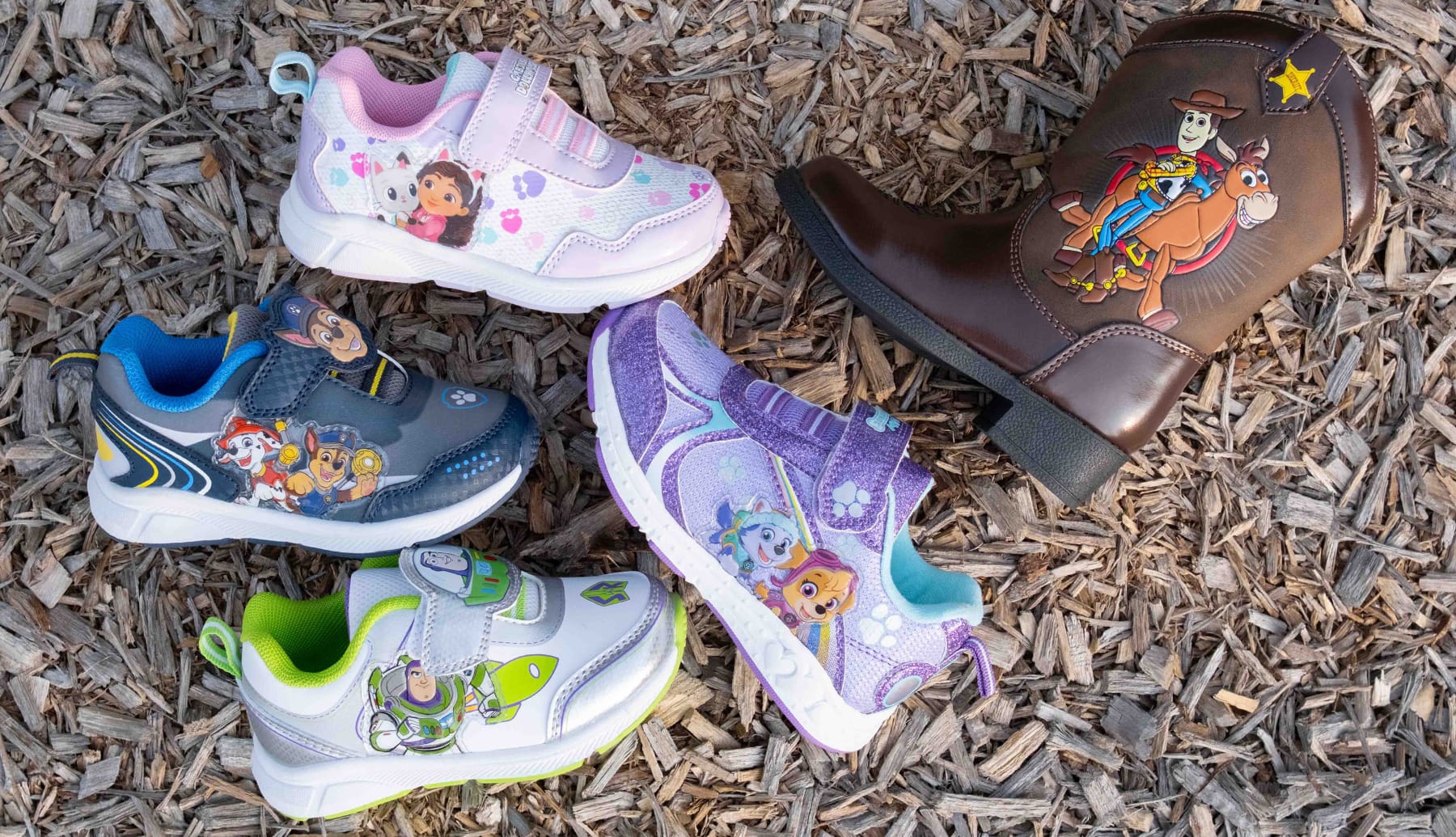 Various kids shoes and boot with cartoon characters on them.