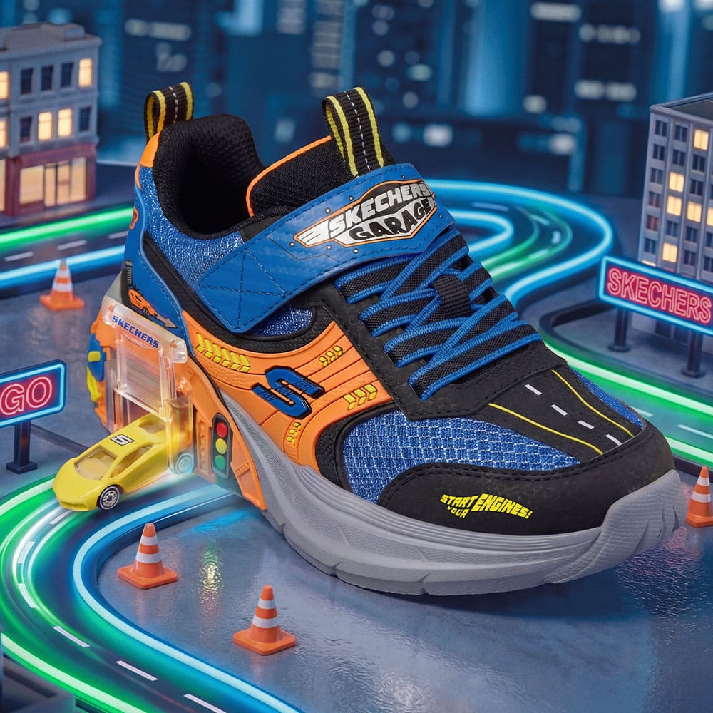 A boys Skechers sneaker in blue and orange with a toy car in the heel.