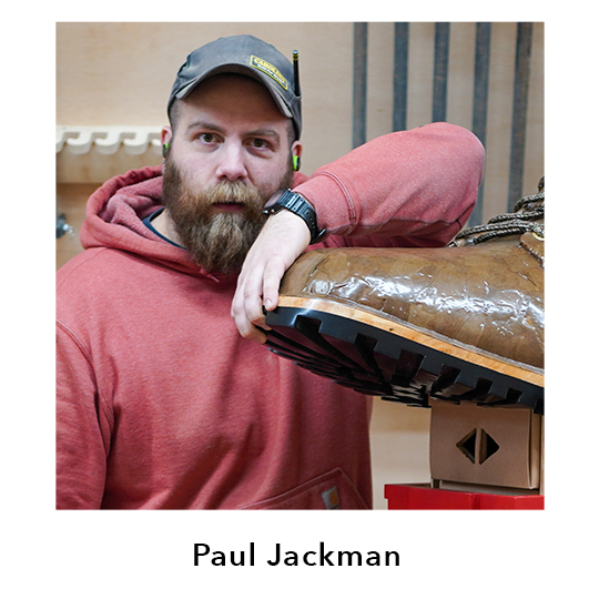 Paul Jackman.  Paul Jackman shown leaning against a large replica of a boot.