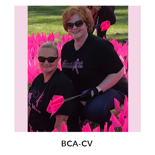 BCA-CV.  Two females distributing pink ribbons shown.