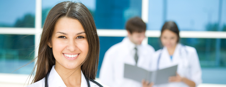 Woman wearing a lab coat.